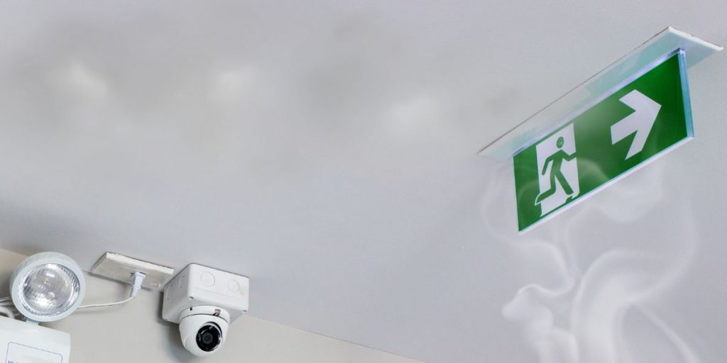 emergency exit sign with cctv camera and smoke viable
