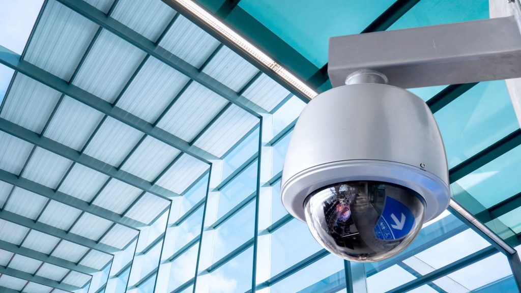 dome cctv camera against a glass wall background